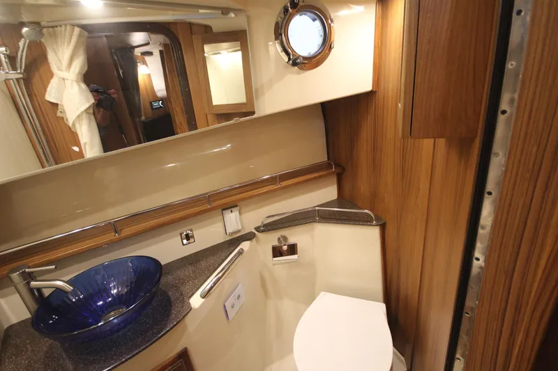 Slide: The Image of Luxurious bathroom in 2026 Ranger Tugs R-31 Command Bridge, featuring elegant wood and modern fixtures. - 65