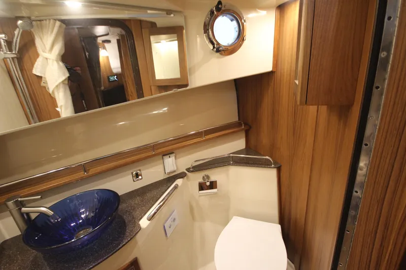 Slide: The Image of Luxurious bathroom in 2026 Ranger Tugs R-31 Command Bridge, featuring elegant wood and modern fixtures. - 66