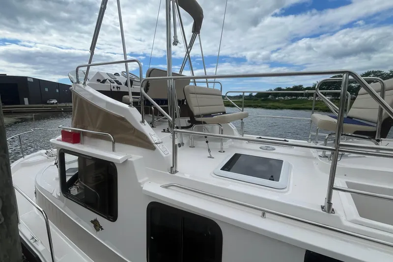 Slide: The Image of 2026 Ranger Tugs R-31 Command Bridge Luxury Edition on water, showcasing upper deck seating. - 7