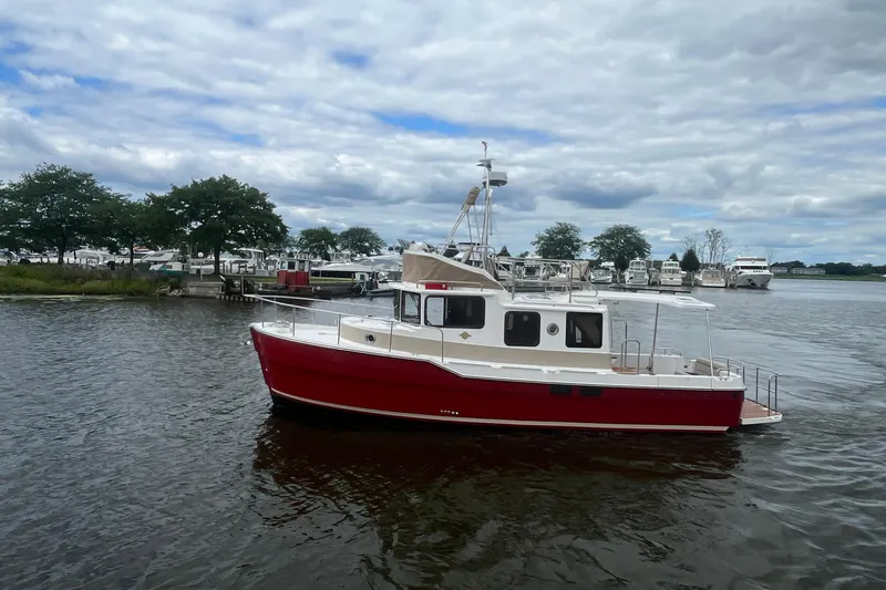 Slide: The Image of 2026 Ranger Tugs R-31 Command Bridge Luxury Edition on a serene lake. - 8