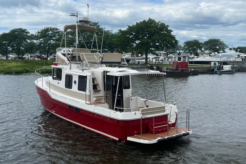 Slide: The Image of 2026 Ranger Tugs R-31 Command Bridge Luxury Edition on a serene waterway. - 9