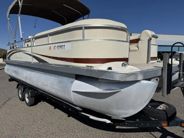 Slide: The Image of 2007 Bennington 2275 GL pontoon boat on trailer, parked outdoors under clear blue sky. - 12
