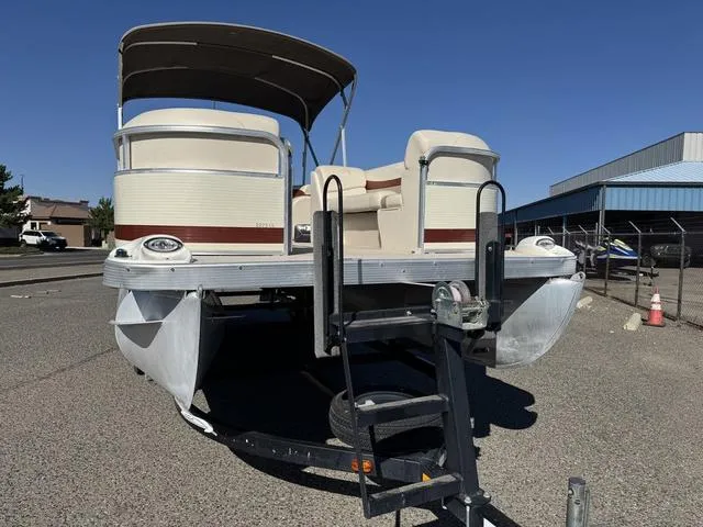 Slide: The Image of 2007 Bennington 2275 GL pontoon boat on trailer, parked outdoors under clear blue sky. - 13