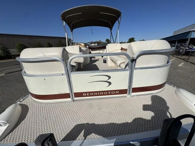 Slide: The Image of 2007 Bennington 2275 GL pontoon boat with canopy, docked under clear blue sky. - 15