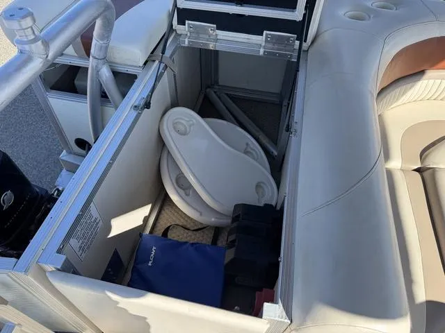 Slide: The Image of 2007 Bennington 2275 GL boat interior with storage compartment and portable toilet. - 40