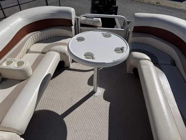Slide: The Image of 2007 Bennington 2275 GL boat interior with round table and cushioned seating. - 48