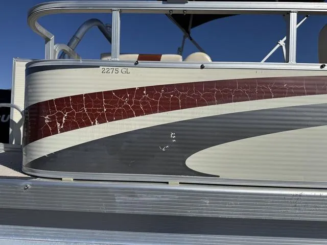 Slide: The Image of 2007 Bennington 2275 GL pontoon boat with cracked red and gray exterior design. - 9