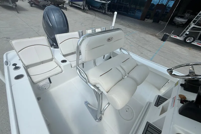 Slide: The Image of 2022 Sea Hunt BX 22 BR boat interior with white seating and steering console. - 11