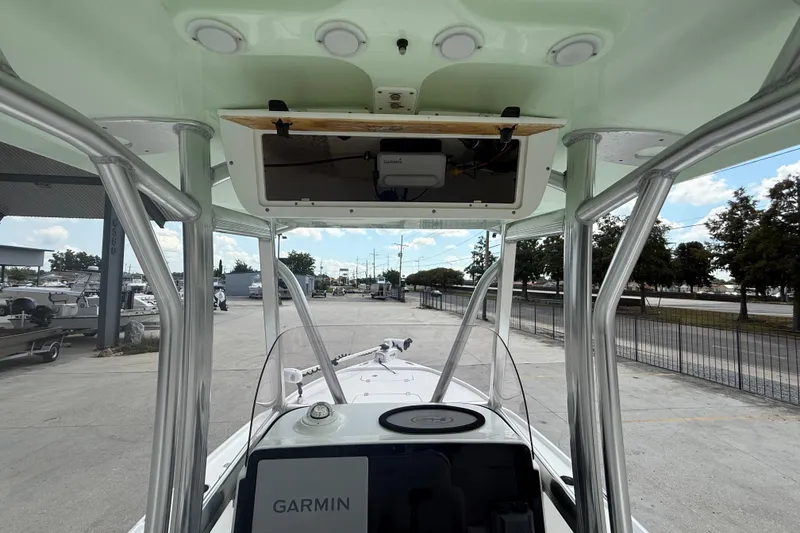 Slide: The Image of 2022 Sea Hunt BX 22 BR boat interior with Garmin navigation system, docked outdoors. - 12