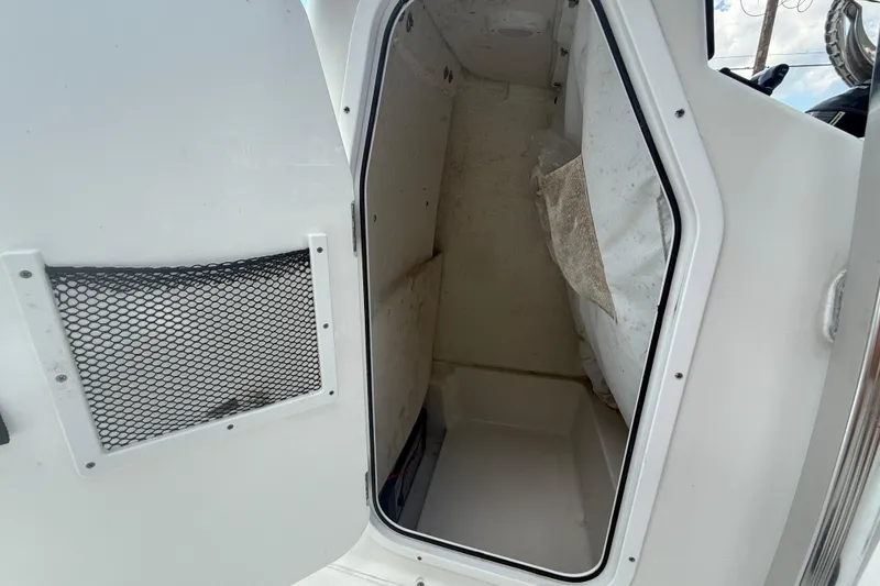 Slide: The Image of 2022 Sea Hunt BX 22 BR boat storage compartment with open door and mesh pocket. - 16