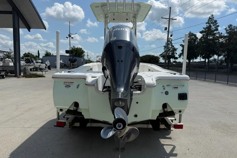 Slide: The Image of 2022 Sea Hunt BX 22 BR boat with powerful outboard motor, parked outdoors. - 5