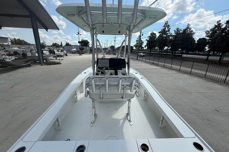 Slide: The Image of 2022 Sea Hunt BX 22 BR boat with center console and T-top in a marina setting. - 7
