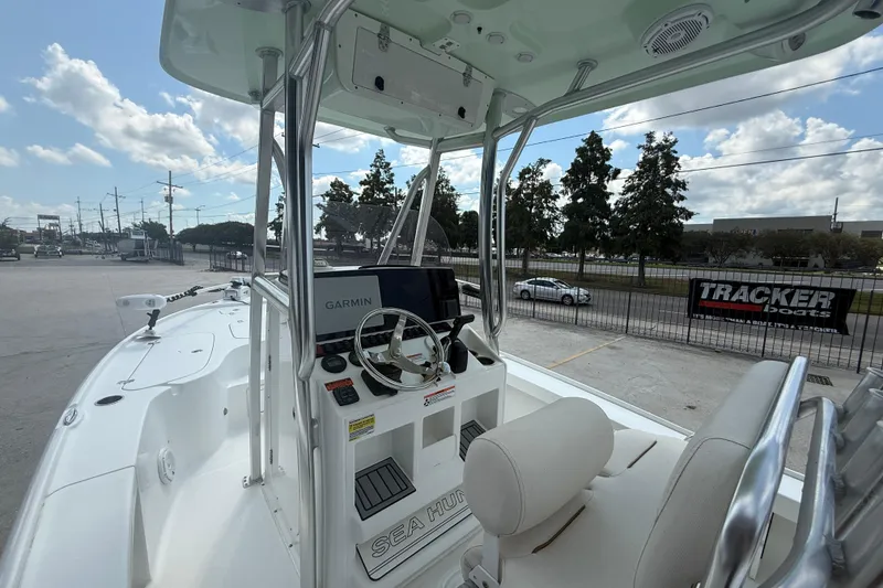 Slide: The Image of 2022 Sea Hunt BX 22 BR boat interior with Garmin navigation system, parked outdoors. - 8