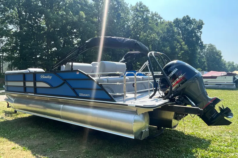 Slide: The Image of 2025 Bentley Pontoons Legacy QSB on grass, featuring Yamaha outboard motor. - 3