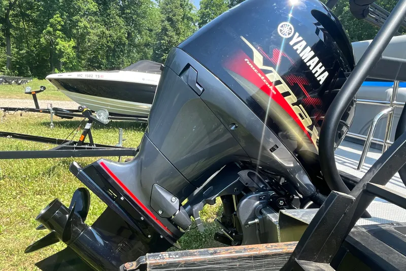 Slide: The Image of 2025 Bentley Pontoons Legacy QSB with Yamaha outboard motor in grassy area. - 4