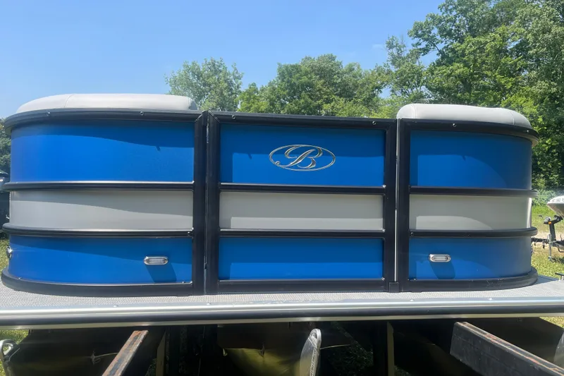 Slide: The Image of 2025 Bentley Pontoons Legacy QSB in blue and gray, docked outdoors. - 8