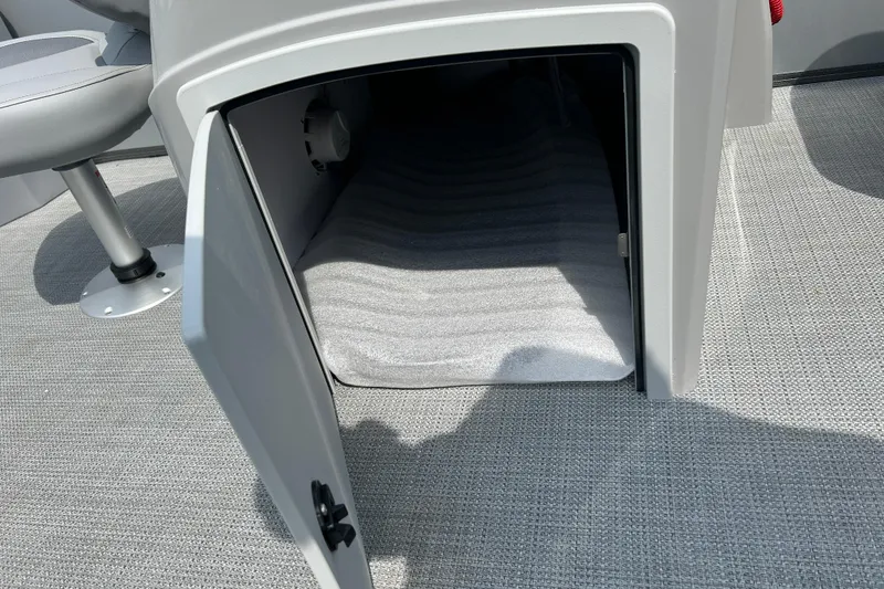 Slide: The Image of Open storage compartment on 2025 Bentley Pontoons LE 180 3PT boat, featuring gray interior. - 20