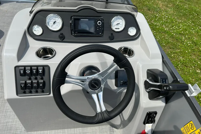 Slide: The Image of 2025 Bentley Pontoons LE 180 3PT dashboard with steering wheel and control panel. - 21
