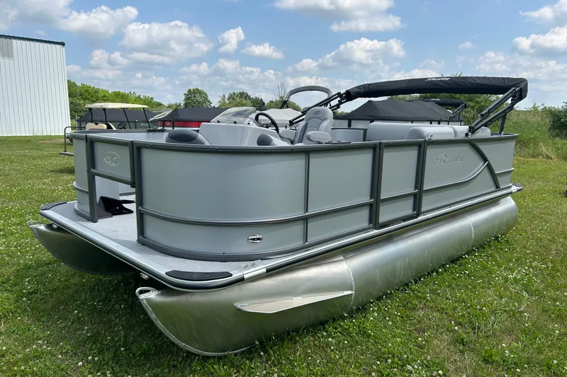 Slide: The Image of 2025 Bentley Pontoons LE 180 3PT on grass, showcasing sleek design and modern features. - 4