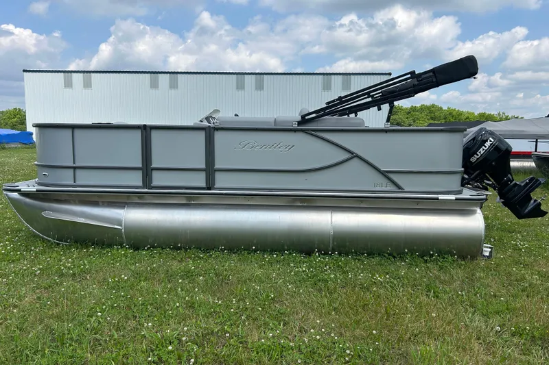 Slide: The Image of 2025 Bentley Pontoons LE 180 3PT on grass, featuring a Suzuki outboard motor. - 5