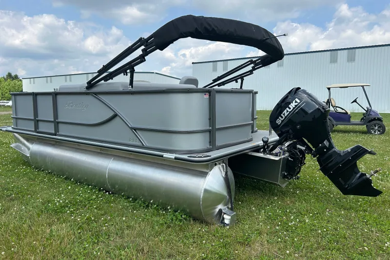 Slide: The Image of 2025 Bentley Pontoons LE 180 3PT with Suzuki outboard motor on grass. - 6