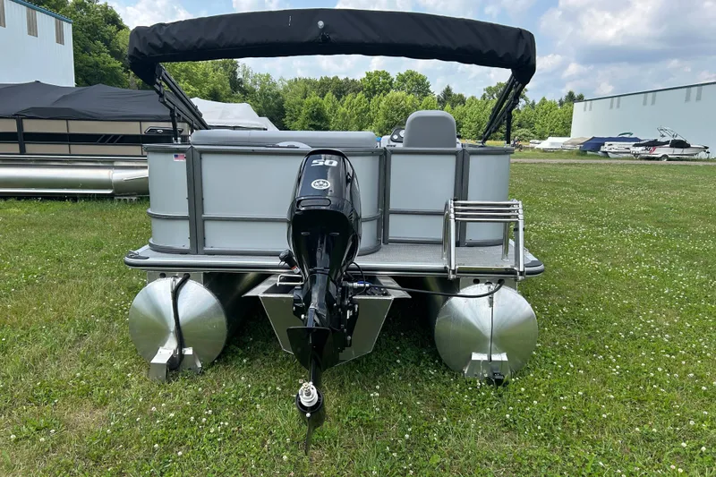 Slide: The Image of 2025 Bentley Pontoons LE 180 3PT on grass, rear view with outboard motor. - 7