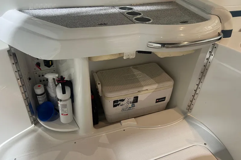 Slide: The Image of 2005 Formula 330 Sun Sport boat storage area with cooler and cleaning supplies. - 12