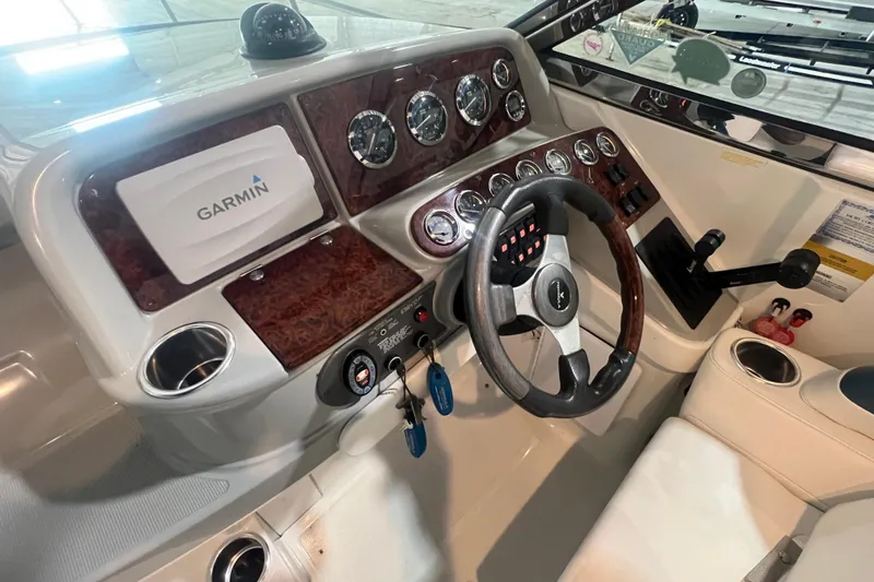 Slide: The Image of 2005 Formula 330 Sun Sport dashboard with Garmin navigation and wood accents. - 13