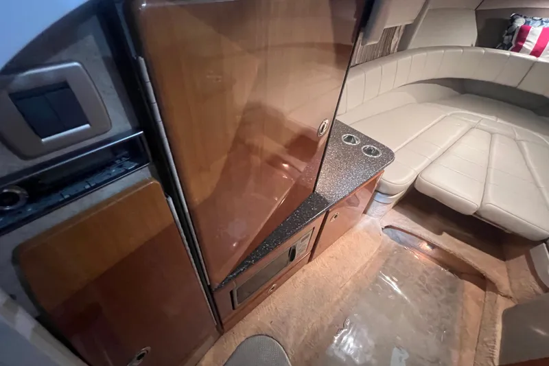 Slide: The Image of 2005 Formula 330 Sun Sport cabin interior with wood cabinetry and beige seating. - 16