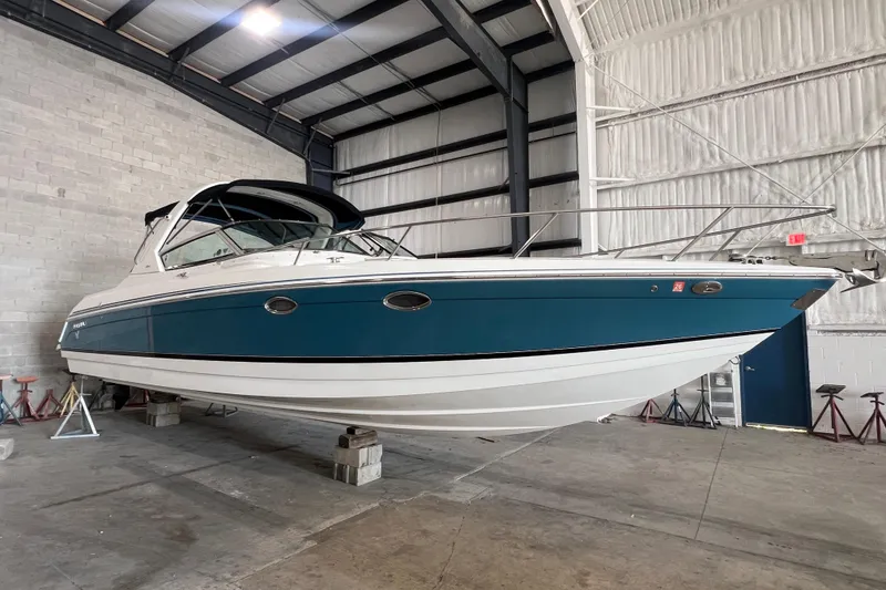 Slide: The Image of 2005 Formula 330 Sun Sport boat in indoor storage, elevated on blocks. - 23