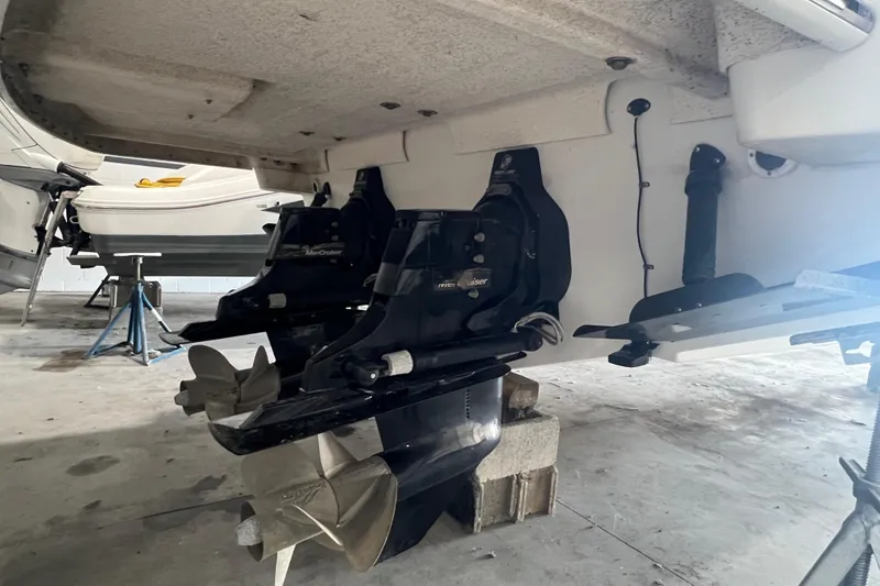 Slide: The Image of 2005 Formula 330 Sun Sport boat with dual propellers in a garage setting. - 4