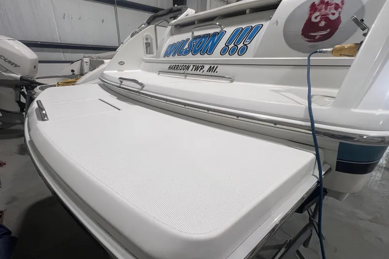 Slide: The Image of 2005 Formula 330 Sun Sport boat with "Wilson" name, docked indoors. - 5