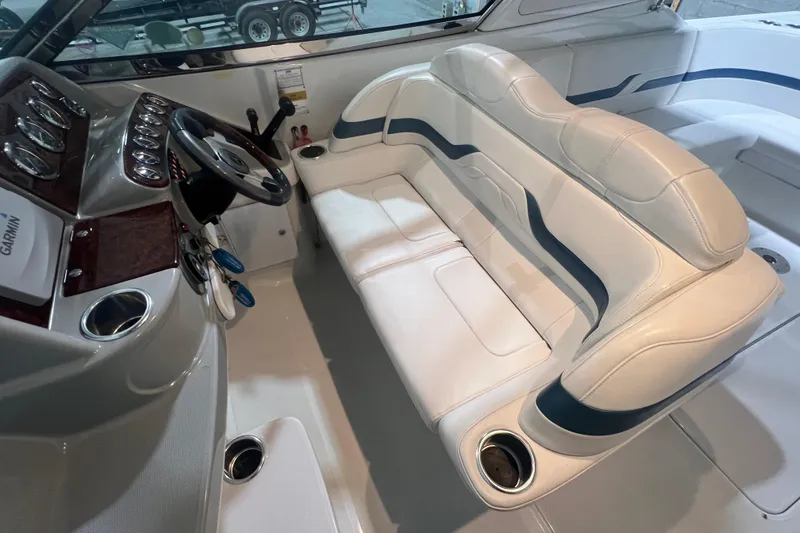 Slide: The Image of 2005 Formula 330 Sun Sport boat interior with white seating and steering console. - 8