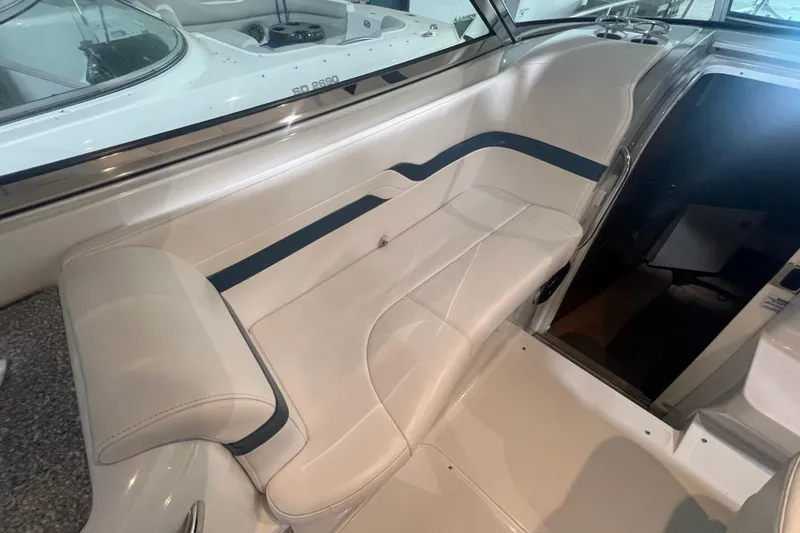 Slide: The Image of 2005 Formula 330 Sun Sport boat interior with white seating and blue accents. - 9