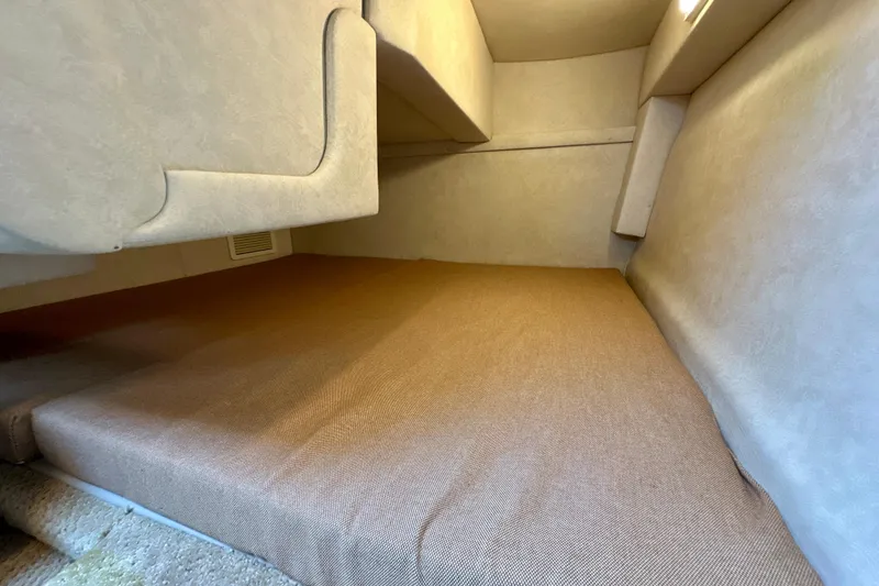 Slide: The Image of Interior cabin of 2012 Sea Ray 240 Sundancer with beige upholstery. - 11