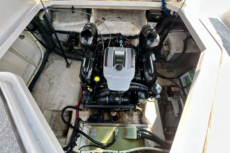 Slide: The Image of Engine compartment of a 2012 Sea Ray 240 Sundancer boat, showcasing the motor and components. - 13
