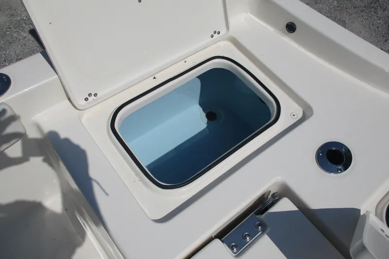 Slide: The Image of Open storage compartment on 2026 Avenger AV26 boat deck. - 11