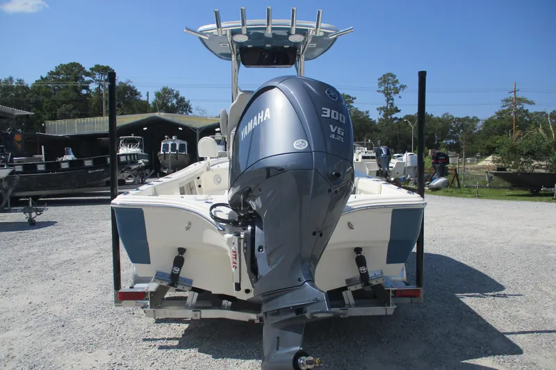 Slide: The Image of Avenger AV26 2026 boat with Yamaha 300 V6 engine, parked outdoors. - 7