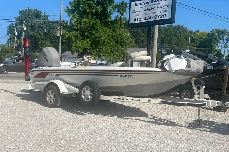Slide: The Image of 2004 Ranger 618 VS boat on trailer, parked outdoors near service center. - 1
