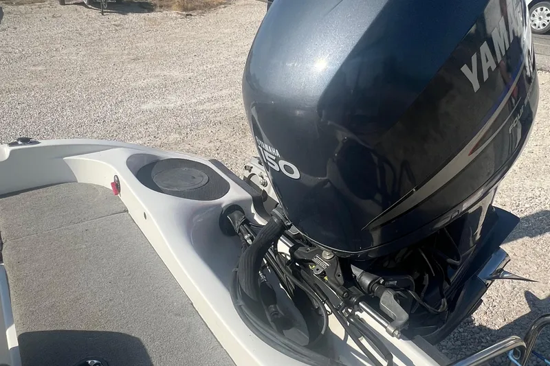 Slide: The Image of 2004 Ranger 618 VS boat with Yamaha 150 outboard motor on gravel surface. - 2