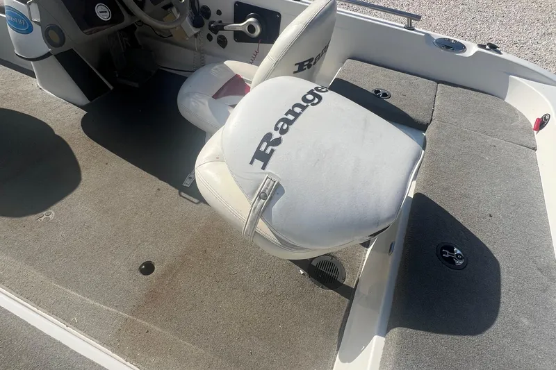 Slide: The Image of 2004 Ranger 618 VS boat interior with steering wheel and branded seat. - 6