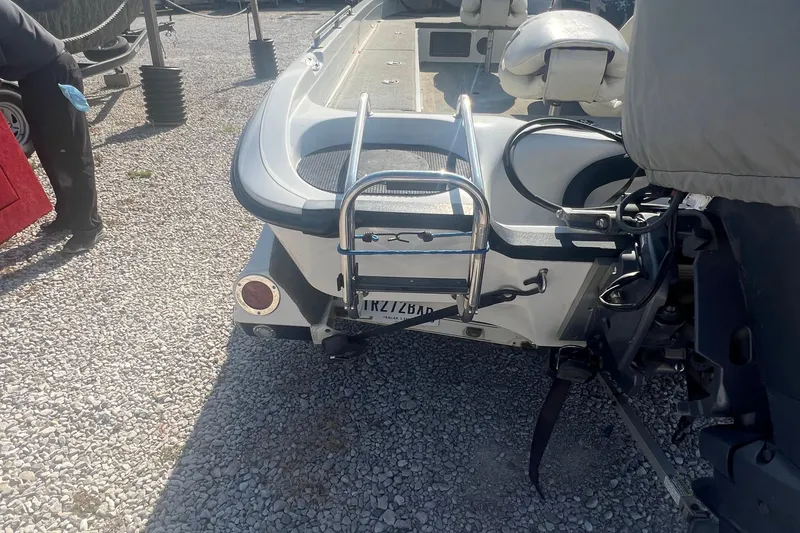 Slide: The Image of 2004 Ranger 618 VS boat rear view with ladder on gravel surface. - 7