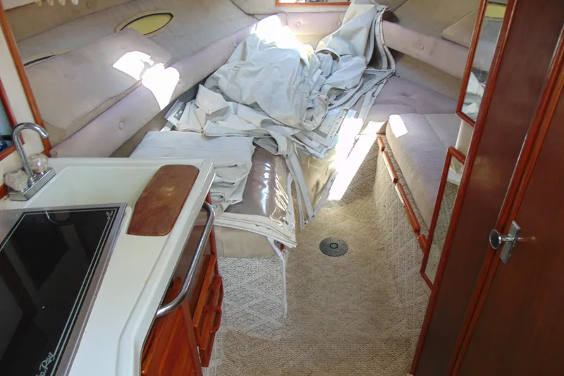 Slide: The Image of Interior of 1988 Sea Ray 270 Amberjack boat with kitchenette and seating area. - 10