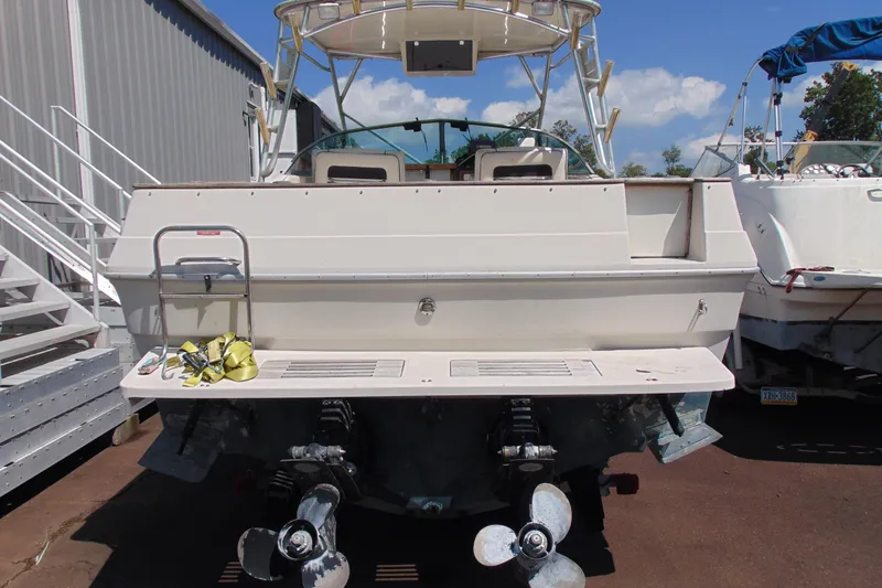 Slide: The Image of 1988 Sea Ray 270 Amberjack boat, rear view with dual propellers and swim platform. - 3