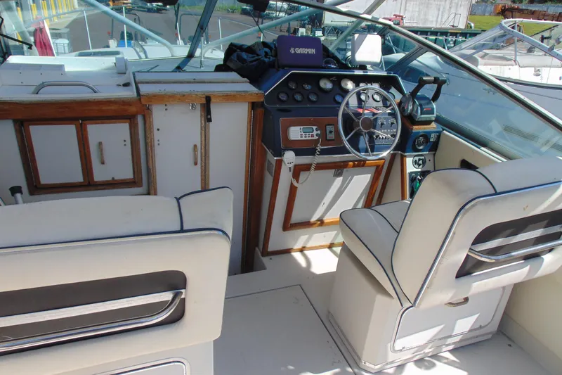 Slide: The Image of 1988 Sea Ray 270 Amberjack boat interior with steering wheel and seating. - 6