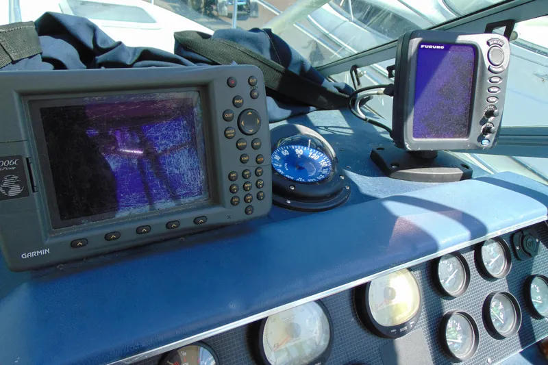 Slide: The Image of Dashboard of a 1988 Sea Ray 270 Amberjack with navigation equipment and gauges. - 8