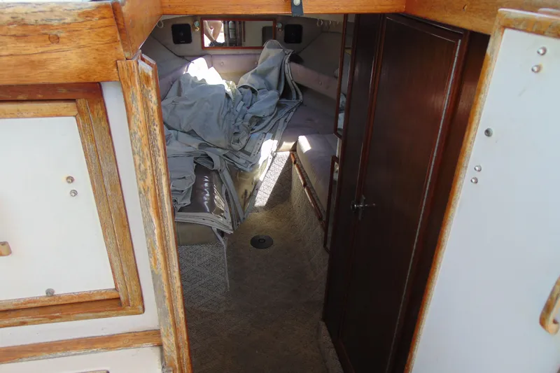 Slide: The Image of Interior cabin of 1988 Sea Ray 270 Amberjack, featuring wood paneling and seating area. - 9