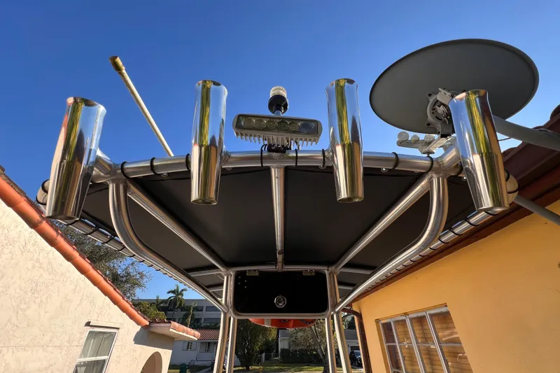 Slide: The Image of 2017 Panga Minsa boat parked between buildings, showcasing steering console and controls. - 12