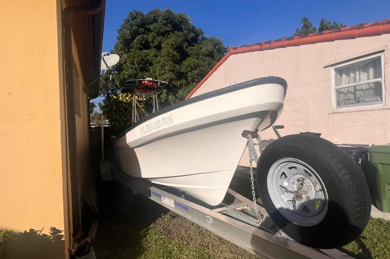 Slide: The Image of 2017 Panga Minsa boat on trailer between two buildings, sunny day. - 3