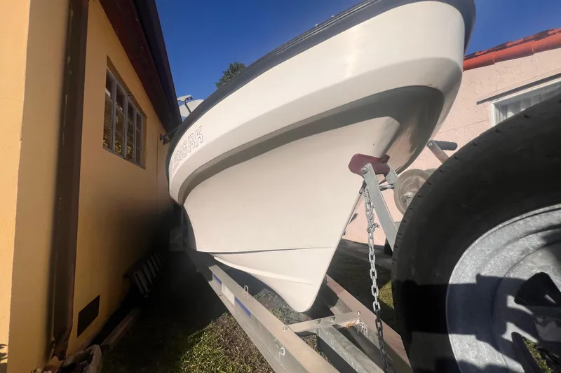 Slide: The Image of 2017 Panga Minsa boat on trailer beside a house, sunny day. - 4